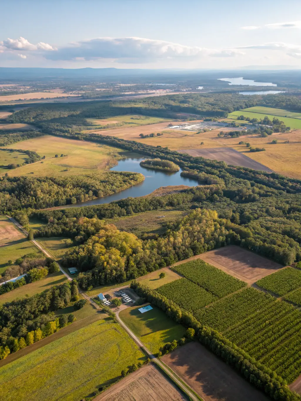 An aerial view of a developing land parcel with overlay graphics highlighting strategic points, showcasing Venture Flow LLC's land acquisition strategies.